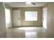 Living room featuring tile flooring and natural light from a large window at 7170 Mountain Moss Dr, Las Vegas, NV 89147