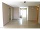 Open living area with tile flooring, light-colored walls, and bright natural light from the entryway at 7170 Mountain Moss Dr, Las Vegas, NV 89147