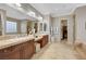 Elegant bathroom with double vanity, granite countertops, and a luxurious walk-in closet at 7181 Barton Creek Ct, Las Vegas, NV 89113
