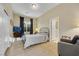 Bright bedroom with light wood floors and a cozy sitting area at 7181 Barton Creek Ct, Las Vegas, NV 89113