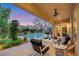 Covered patio provides an inviting outdoor living space with a view of the pool and landscaped backyard at 7181 Barton Creek Ct, Las Vegas, NV 89113