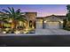 Charming single-Gathering home with manicured landscaping, stone accents, and a three-car garage at dusk at 7181 Barton Creek Ct, Las Vegas, NV 89113