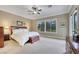 Serene main bedroom with a king-size bed, natural light, and an en-suite bathroom at 7181 Barton Creek Ct, Las Vegas, NV 89113