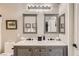 Bathroom featuring dual vanity with modern fixtures, framed mirrors, and great lighting at 7250 Diamond Canyon Ln # 204, Las Vegas, NV 89149