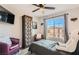 Inviting bedroom with ceiling fan, decorative cabinet, and natural light streaming through the window at 7250 Diamond Canyon Ln # 204, Las Vegas, NV 89149