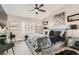 Stylish bedroom with a ceiling fan, textured bedding, and mirrored side tables at 7250 Diamond Canyon Ln # 204, Las Vegas, NV 89149