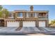 Modern exterior view featuring multi-car garages and a Spanish-style roof at 7250 Diamond Canyon Ln # 204, Las Vegas, NV 89149