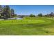 Picturesque view of the golf course with lush green grass, trees, and a tranquil pond at 7250 Diamond Canyon Ln # 204, Las Vegas, NV 89149