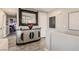 Hallway featuring a modern accent cabinet, neutral walls, and views into the bedroom at 7250 Diamond Canyon Ln # 204, Las Vegas, NV 89149