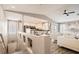 Bright, open-concept living room with white sofas, vaulted ceilings, and a glimpse of the kitchen area at 7250 Diamond Canyon Ln # 204, Las Vegas, NV 89149