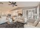 Bright living room with white seating, a ceiling fan, and a view into the kitchen at 7250 Diamond Canyon Ln # 204, Las Vegas, NV 89149