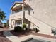 Condo exterior with stairway, red rock landscaping, green railing, and sidewalk at 7450 S Eastern Ave # 1059, Las Vegas, NV 89123