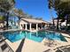 Community pool featuring lounge chairs with palm trees at 7450 S Eastern Ave # 1059, Las Vegas, NV 89123