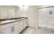 Bathroom featuring double sinks, granite countertops, and a glass-enclosed shower at 7605 Moore Creek Ln, North Las Vegas, NV 89084