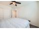 Bright bedroom featuring a ceiling fan, a closet with sliding doors, and neutral carpeting at 7605 Moore Creek Ln, North Las Vegas, NV 89084