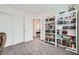Bedroom featuring neutral carpet, closet with sliding doors and a bookcase with books and decor at 7605 Moore Creek Ln, North Las Vegas, NV 89084