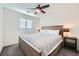 Cozy bedroom with plush carpet, a ceiling fan, and a comfy queen-sized bed at 7605 Moore Creek Ln, North Las Vegas, NV 89084