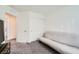 Neutral bedroom featuring a futon and closet with sliding doors at 7605 Moore Creek Ln, North Las Vegas, NV 89084