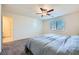 Bright, spacious bedroom with a plush carpet, ceiling fan and ample natural light at 7605 Moore Creek Ln, North Las Vegas, NV 89084