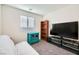 Bedroom with bookcase, television, and futon for flexible use at 7605 Moore Creek Ln, North Las Vegas, NV 89084