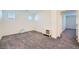Bonus room with neutral carpet, two windows and a small console table at 7605 Moore Creek Ln, North Las Vegas, NV 89084