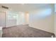 Bonus room with neutral carpet, a door to outside and stairs at 7605 Moore Creek Ln, North Las Vegas, NV 89084