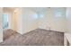 Bonus room with neutral carpet, two windows and a small console table at 7605 Moore Creek Ln, North Las Vegas, NV 89084