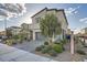 Inviting two-story home with a paved driveway, complemented by a neatly landscaped front yard at 7605 Moore Creek Ln, North Las Vegas, NV 89084