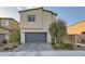 Two story home featuring a front yard with desert landscaping and a brick paved driveway at 7605 Moore Creek Ln, North Las Vegas, NV 89084