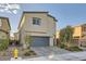 Charming two-story home featuring a gray garage door and a well-manicured front yard at 7605 Moore Creek Ln, North Las Vegas, NV 89084
