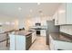 Well-appointed kitchen featuring white cabinets, granite countertops, and stainless steel appliances at 7605 Moore Creek Ln, North Las Vegas, NV 89084