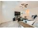 Bright living room with plush seating, large windows, and a modern ceiling fan at 7605 Moore Creek Ln, North Las Vegas, NV 89084