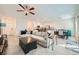 Bright, open-concept living space featuring tile floors seamlessly flowing into the modern kitchen at 7605 Moore Creek Ln, North Las Vegas, NV 89084