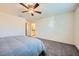 Spacious main bedroom features a ceiling fan and neutral carpet at 7605 Moore Creek Ln, North Las Vegas, NV 89084