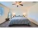 Bright main bedroom with large bed, ceiling fan, and natural light at 7605 Moore Creek Ln, North Las Vegas, NV 89084