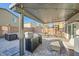 Charming covered patio area with pavers, outdoor seating, and custom cat enclosure for outdoor enjoyment at 7605 Moore Creek Ln, North Las Vegas, NV 89084