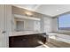 Bright bathroom with double sinks, large mirror, soaking tub and city views at 8255 Las Vegas Blvd # 1315, Las Vegas, NV 89123