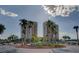 Exterior shot features roundabout with well manicured foliage and palm trees leading up to the modern condo buildings at 8255 Las Vegas Blvd # 1315, Las Vegas, NV 89123