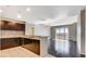 Open kitchen and living area with stainless steel appliances, granite countertops, and hardwood floors at 8255 Las Vegas Blvd # 1315, Las Vegas, NV 89123