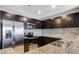 Close up of gourmet kitchen with stainless steel appliances, granite countertops and tile backsplash at 8255 Las Vegas Blvd # 1315, Las Vegas, NV 89123