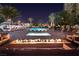 This outdoor pool area features a spa, fire pit, lounge seating, and palm trees at 8255 Las Vegas Blvd # 1315, Las Vegas, NV 89123