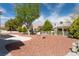 Inviting backyard with desert landscaping, comfortable seating, mature shade trees, and a well-kept patio at 8812 Marble Dr, Las Vegas, NV 89134