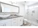 Bright bathroom features double sinks, granite countertop, large mirror, and glass-enclosed shower at 8812 Marble Dr, Las Vegas, NV 89134