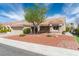 Inviting single-story home with desert landscaping, mature tree, and a covered front porch at 8812 Marble Dr, Las Vegas, NV 89134
