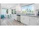 Open kitchen featuring sleek white cabinetry, granite counters, and stainless steel appliances at 8812 Marble Dr, Las Vegas, NV 89134