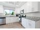 Bright kitchen with white cabinets, granite countertops, stainless steel appliances, and lots of natural light at 8812 Marble Dr, Las Vegas, NV 89134
