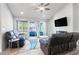 Bright living room with plush seating, modern fireplace, and sliding glass doors to outdoor space at 8812 Marble Dr, Las Vegas, NV 89134