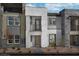 Contemporary three-story home featuring a modern design with stone accents and multiple balconies at 887 Apatite Pl # Lot 58, Henderson, NV 89011