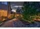 Charming backyard with a winding pathway, pergola, and beautiful garden beds, ideal for relaxation at 8944 Campanella St, Las Vegas, NV 89123