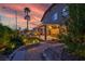 Spacious backyard featuring a covered patio, a lounge area, and lush landscaping, perfect for outdoor living at 8944 Campanella St, Las Vegas, NV 89123